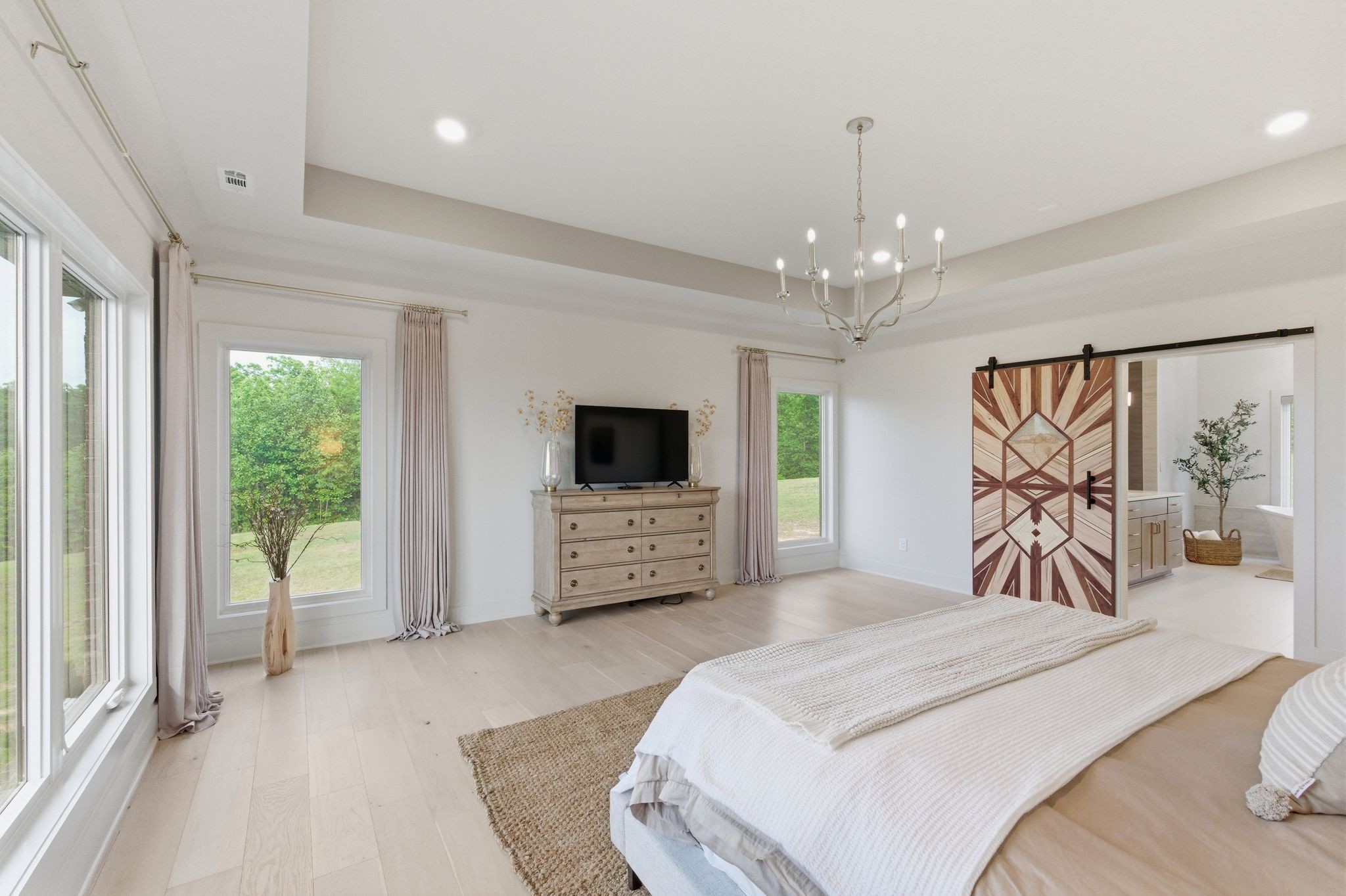 577 Box House Road Belvidere, TN 37306 - Photo 28 of 77 a bedroom with a large bed and a flat tv screen