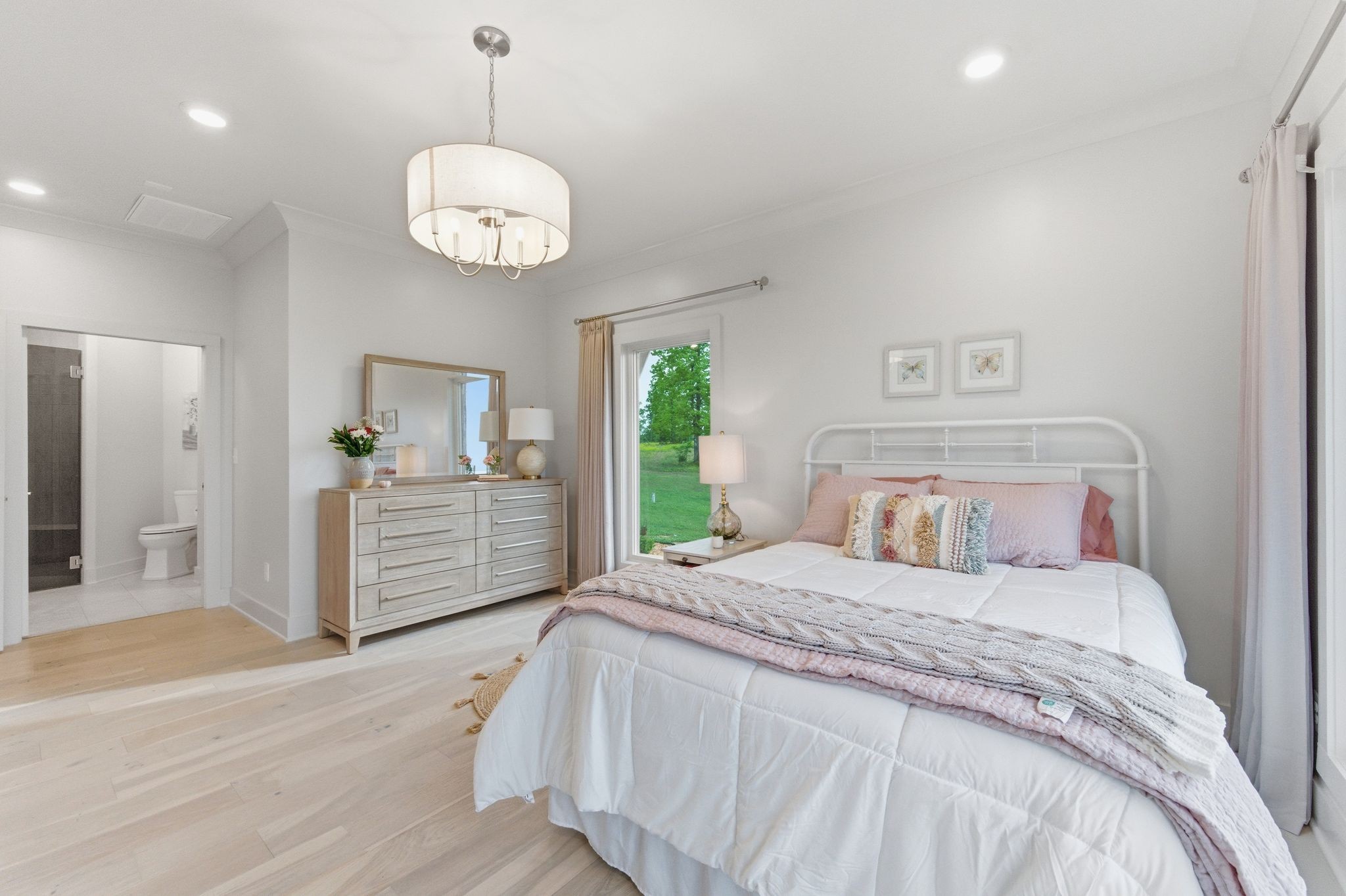 577 Box House Road Belvidere, TN 37306 - Photo 39 of 77 a bedroom with a large bed and a chandelier