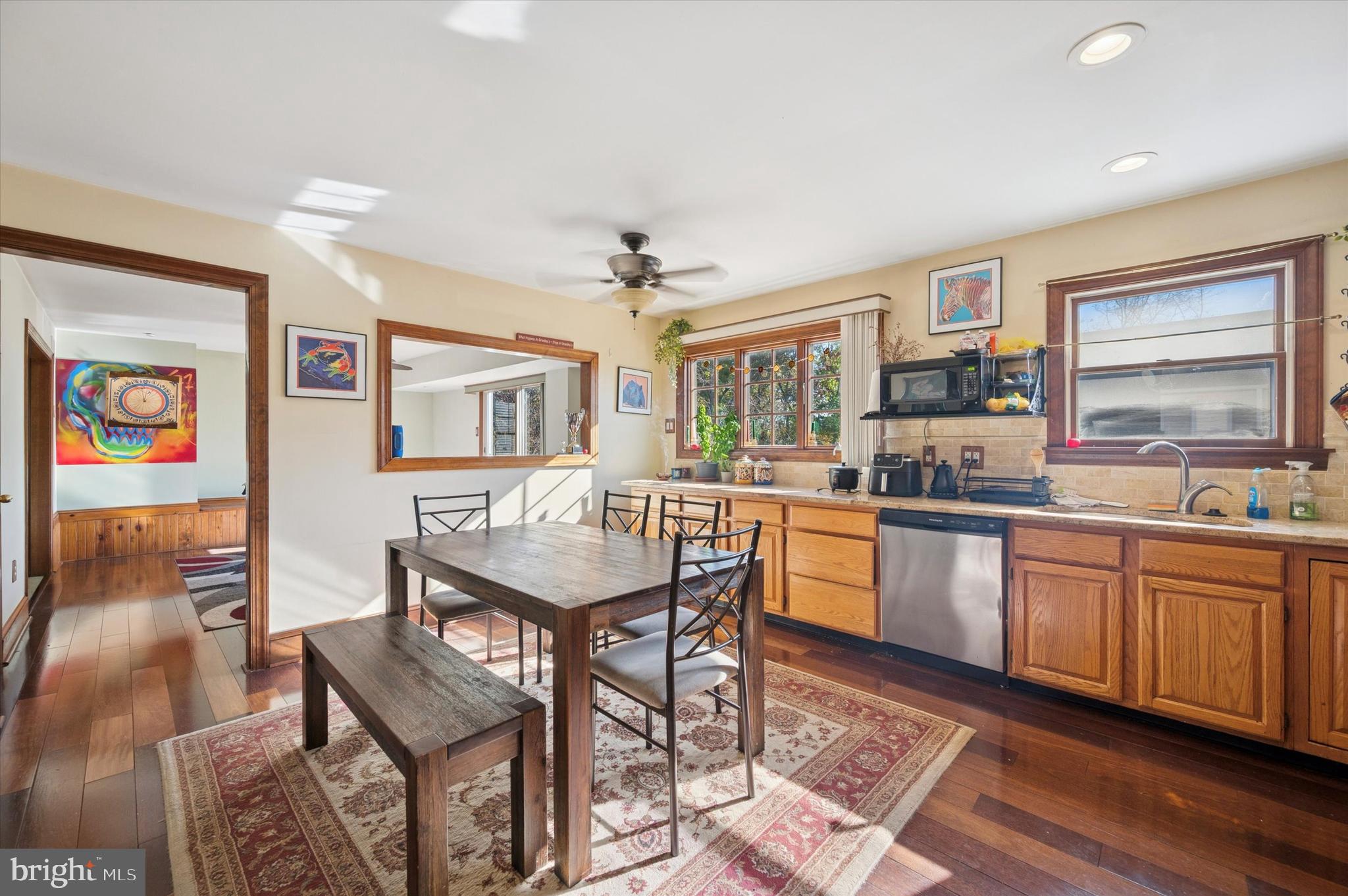 205 Delmar Street Philadelphia, PA 19128 - Photo 16 of 25 a kitchen with stainless steel appliances granite countertop a stove a sink dishwasher and a refrigerator with wooden floor
