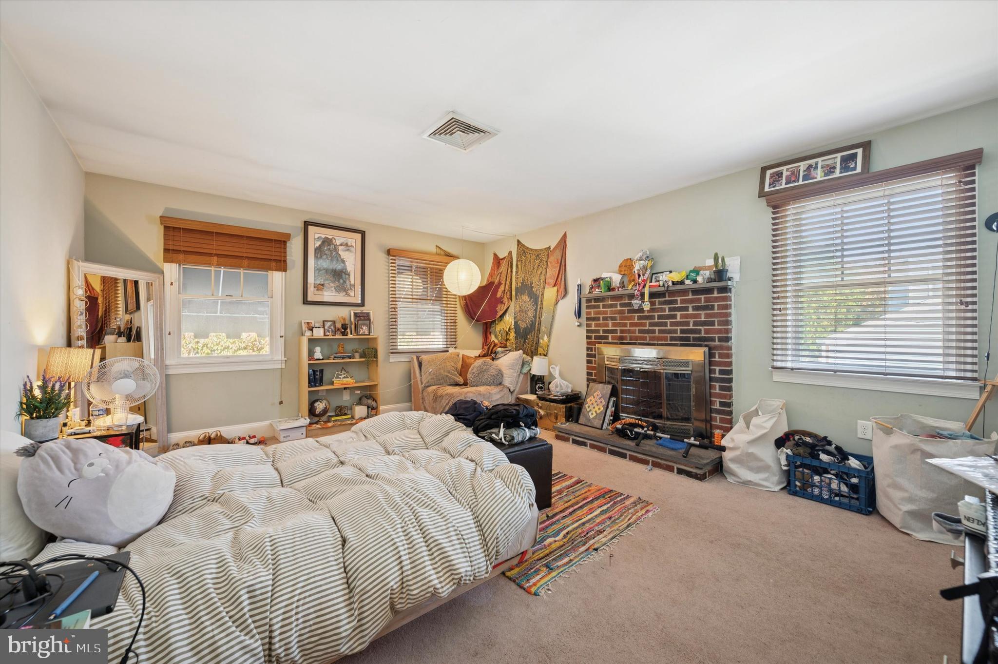 205 Delmar Street Philadelphia, PA 19128 - Photo 9 of 25 a bedroom with a bed and glass windows