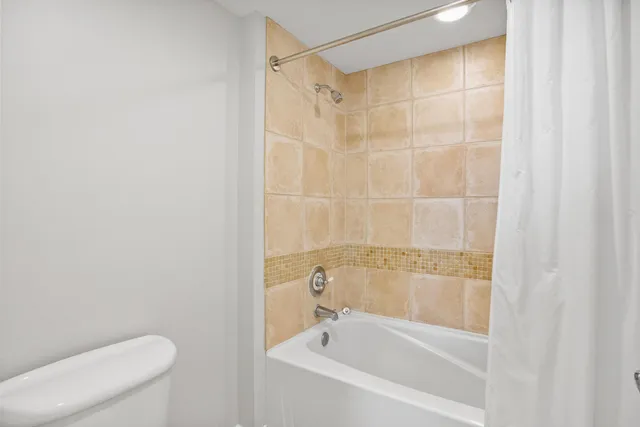 a bathroom with a shower and a toilet