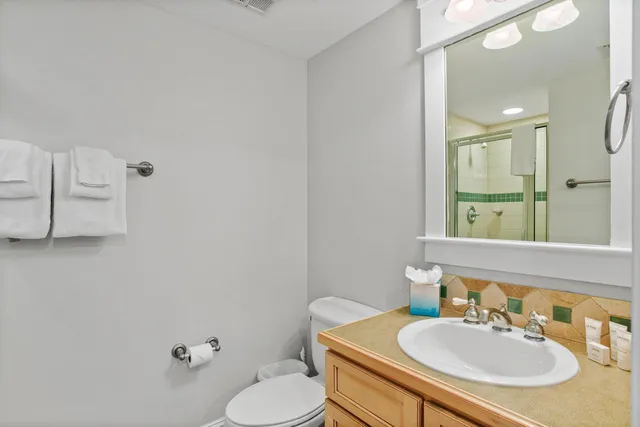 a bathroom with a sink toilet and mirror