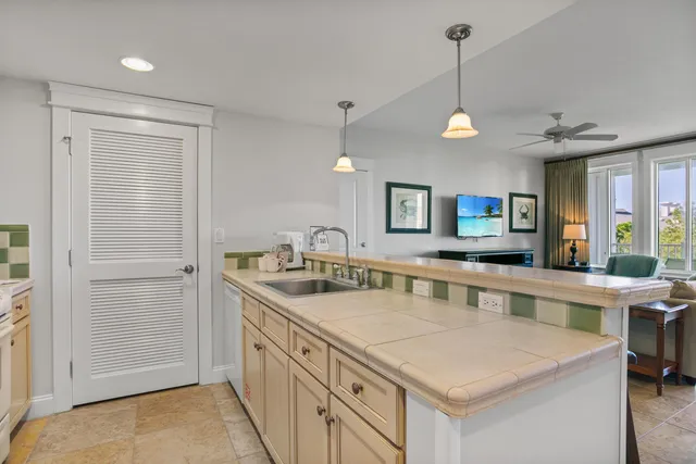 a kitchen with stainless steel appliances granite countertop a sink a stove and a refrigerator