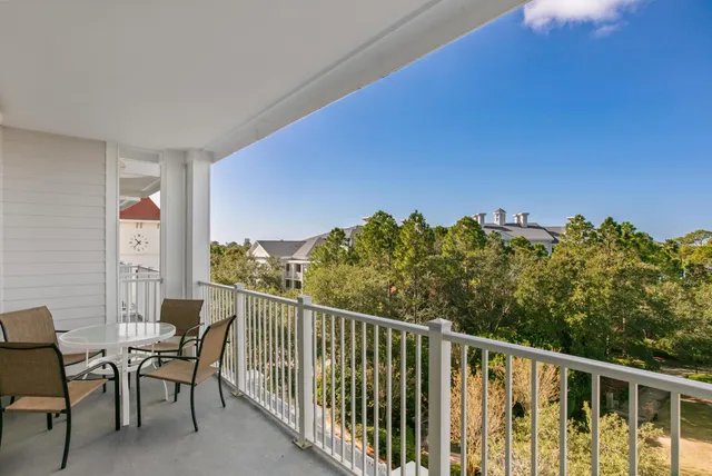 a view of a chairs and table in a balcony