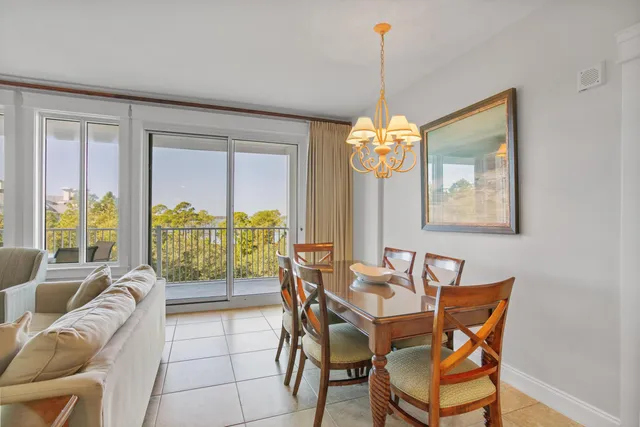 a dining room with furniture a chandelier and wooden floor