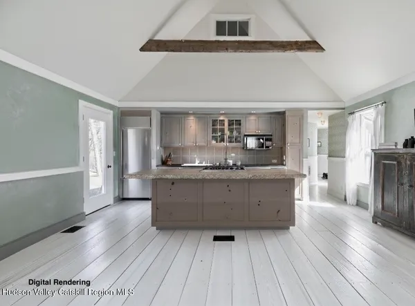 a kitchen with stainless steel appliances kitchen island wooden floors and wooden cabinets