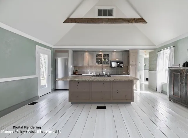 a kitchen with stainless steel appliances kitchen island wooden floors and wooden cabinets