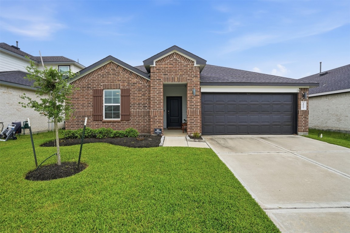 a front view of a house with a yard and garage