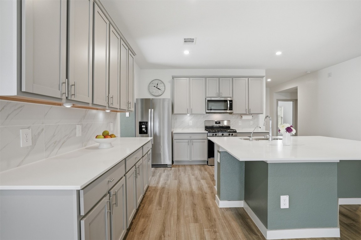 1022 Curly Angora Court Rosharon, TX 77583 - Photo 7 of 17 a kitchen with stainless steel appliances a sink dishwasher stove refrigerator and cabinets