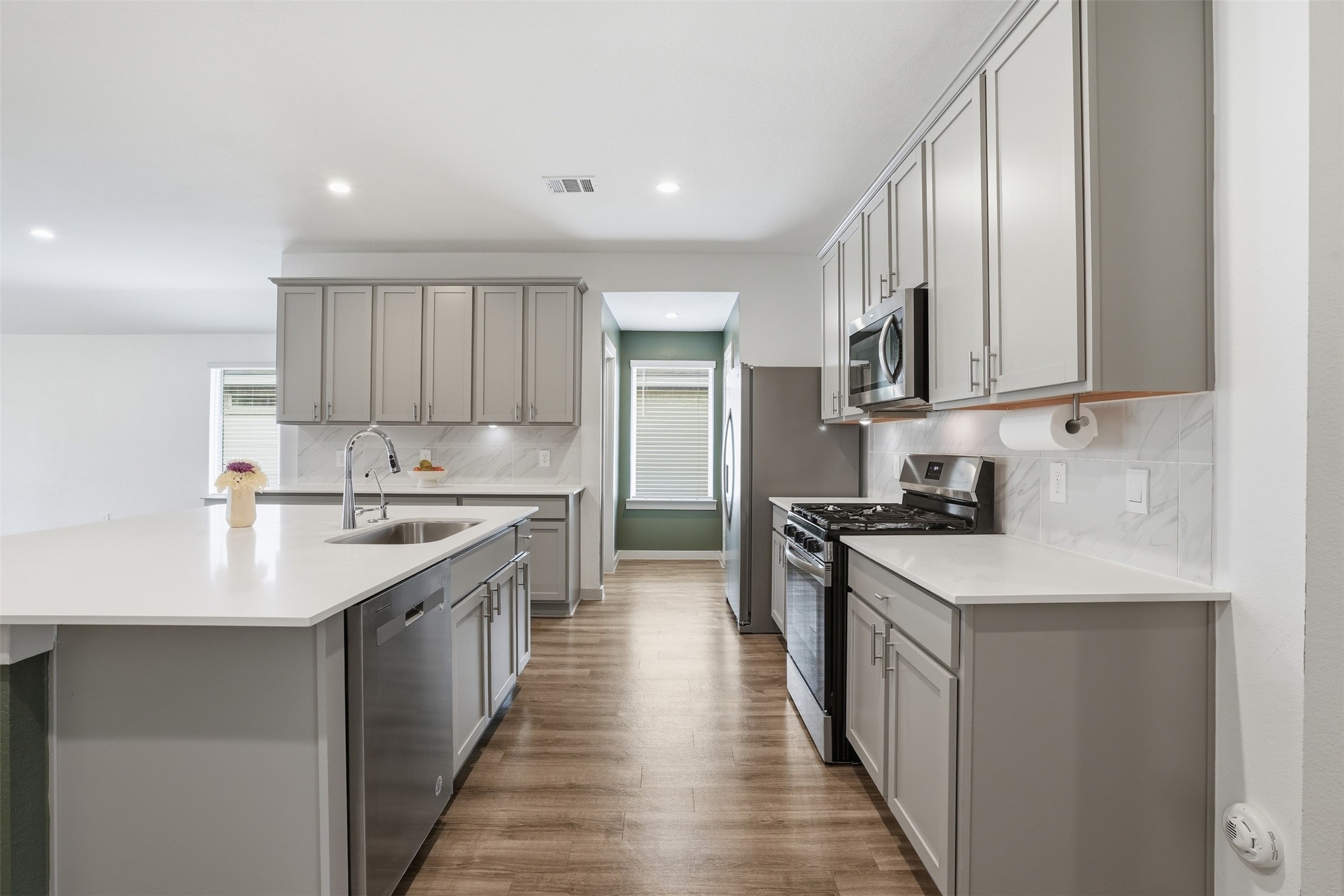 1022 Curly Angora Court Rosharon, TX 77583 - Photo 8 of 17 Convenient kitchen layout with direct access to the utility space—making daily routines effortless.
