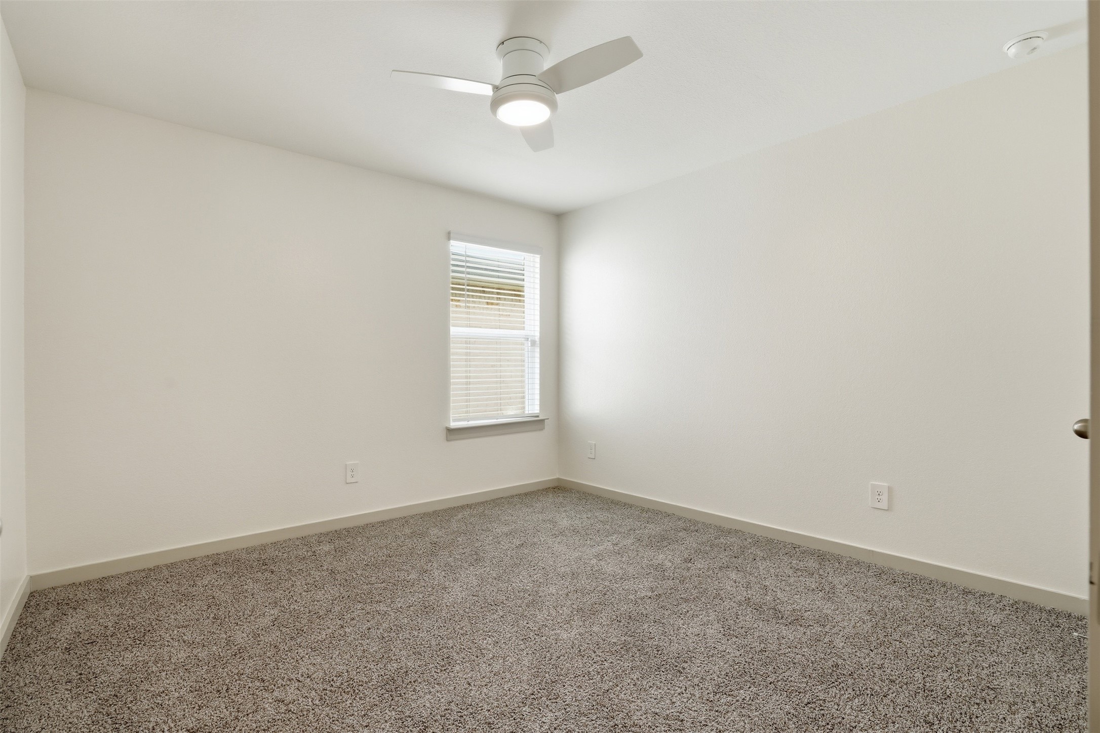 1022 Curly Angora Court Rosharon, TX 77583 - Photo 10 of 17 Comfortable second bedroom featuring a sleek, modern ceiling fan and versatile layout.
