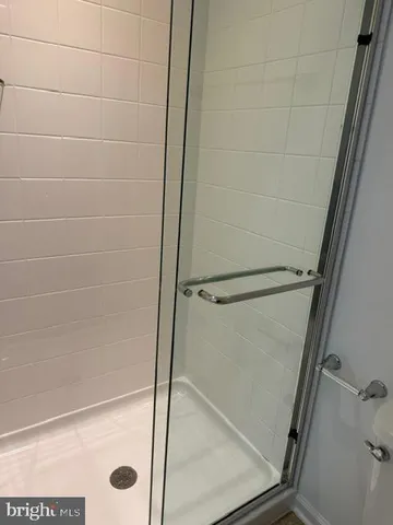 a bathroom with a glass shower door