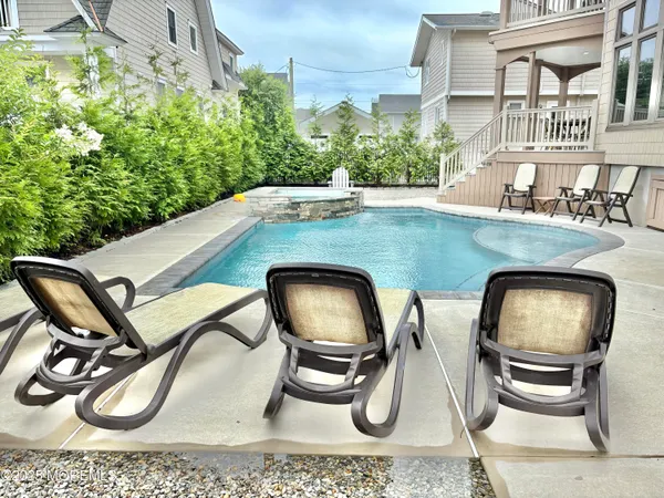 a backyard of a house with table and chairs