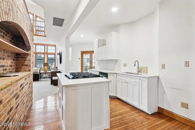 a kitchen with stainless steel appliances granite countertop a stove and a sink