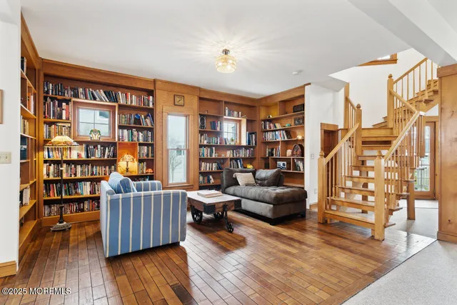 a living room with furniture and a book shelf