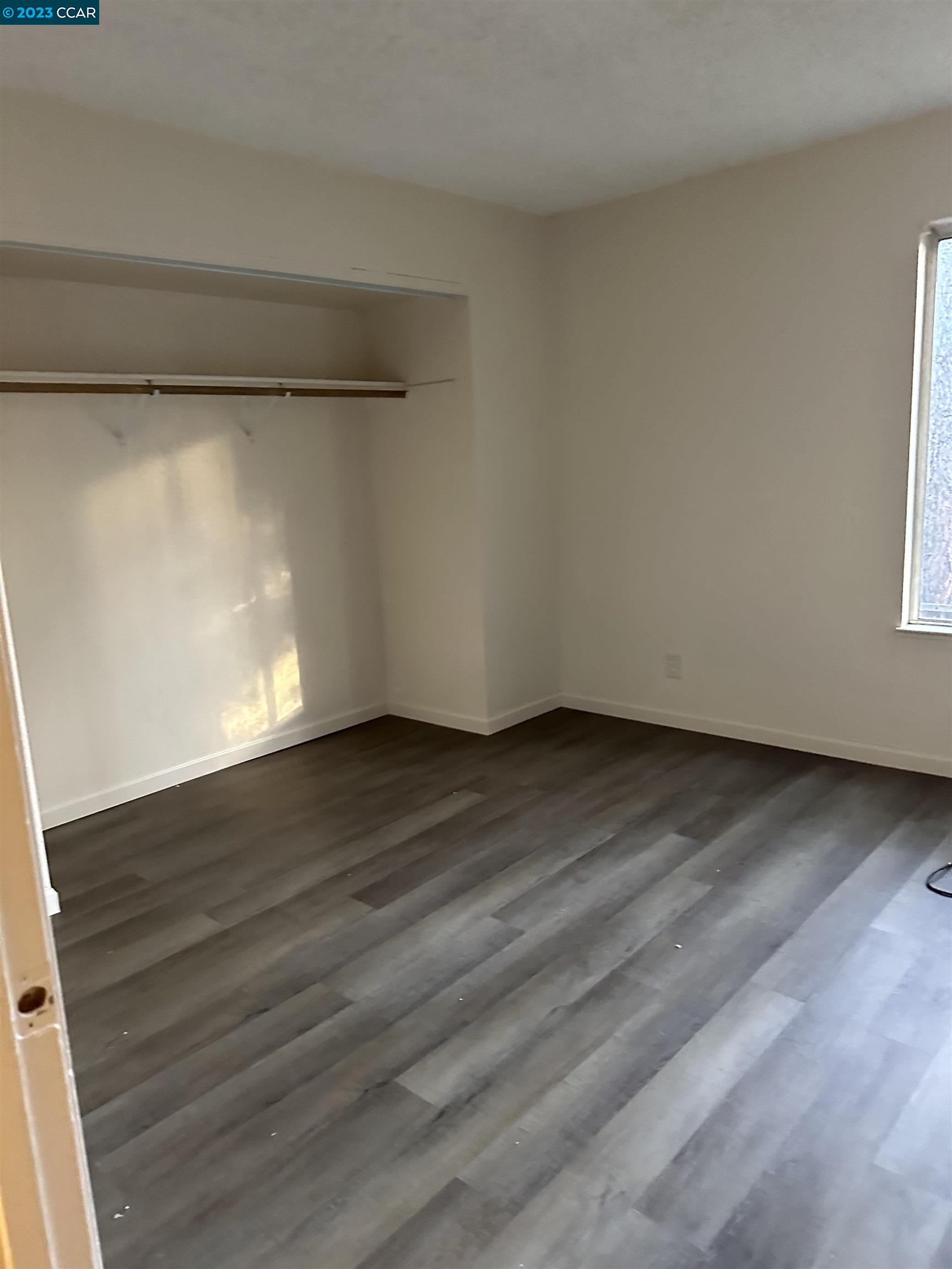 5460 Concord Boulevard Concord, CA 94521 - Photo 12 of 35 a view of an empty room with wooden floor and a window