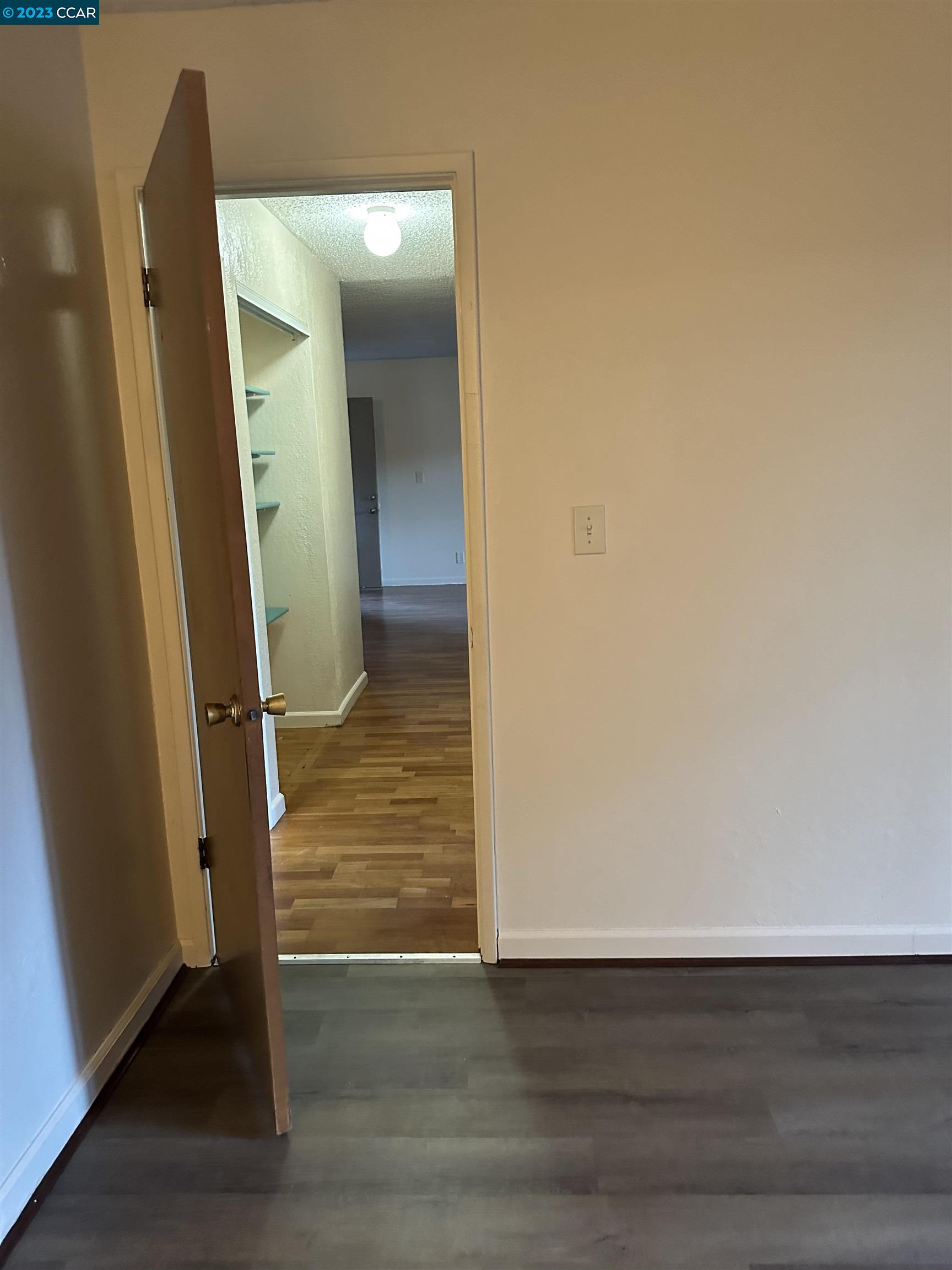 5460 Concord Boulevard Concord, CA 94521 - Photo 15 of 35 an empty room with wooden floor and mirror