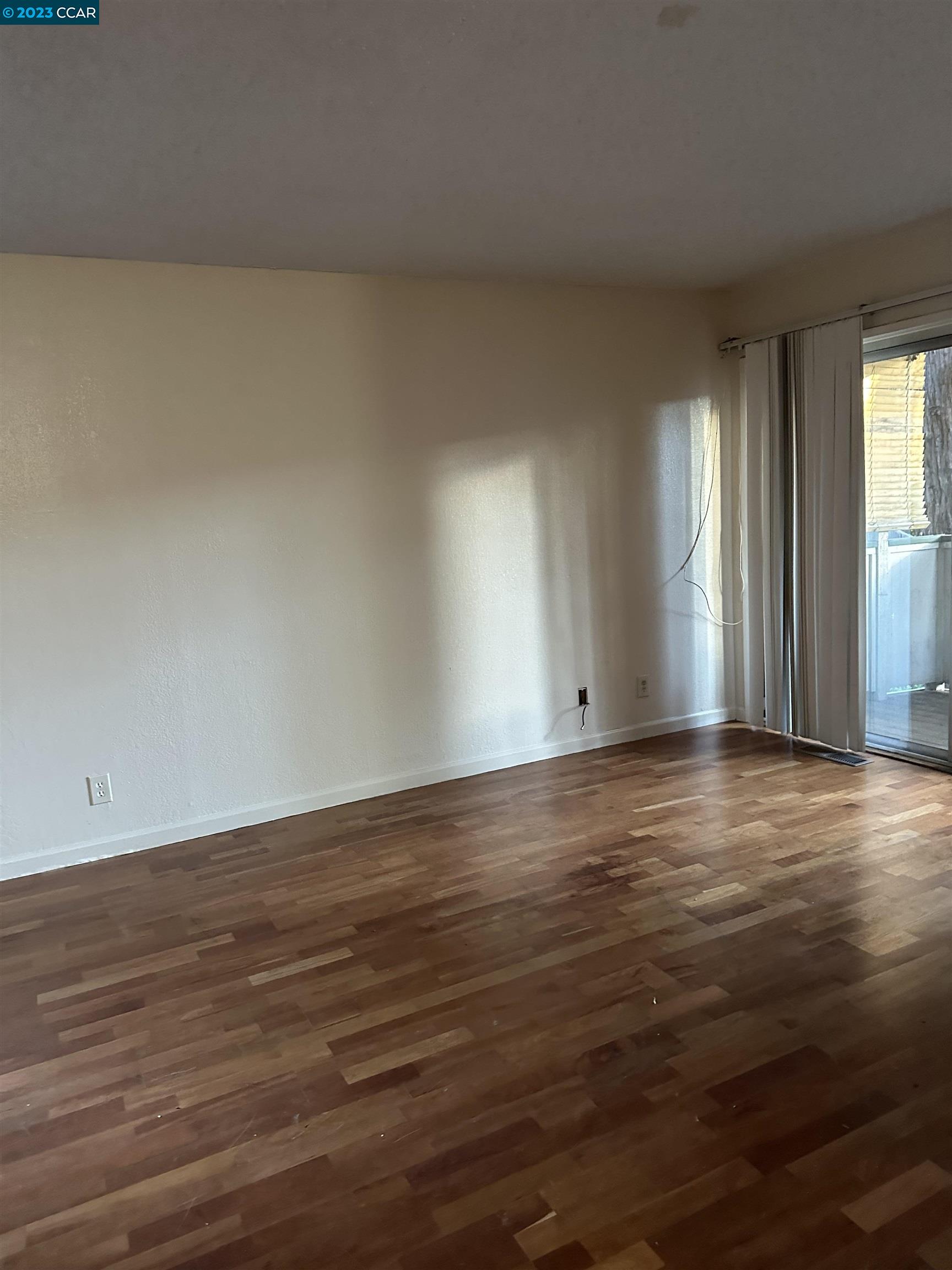 5460 Concord Boulevard Concord, CA 94521 - Photo 7 of 35 a view of an empty room with wooden floor and a window