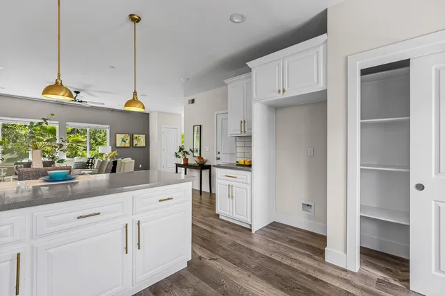 a kitchen with white cabinets and white appliances