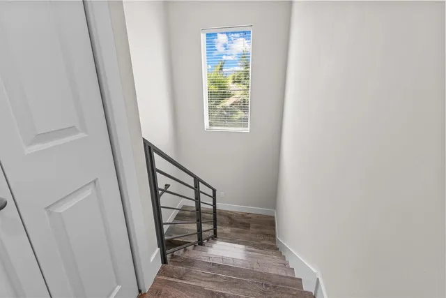 a view of a hallway with wooden floor and entryway