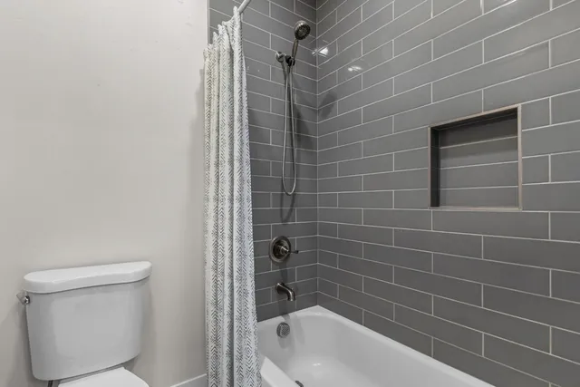 a bathroom with a bathtub and a toilet