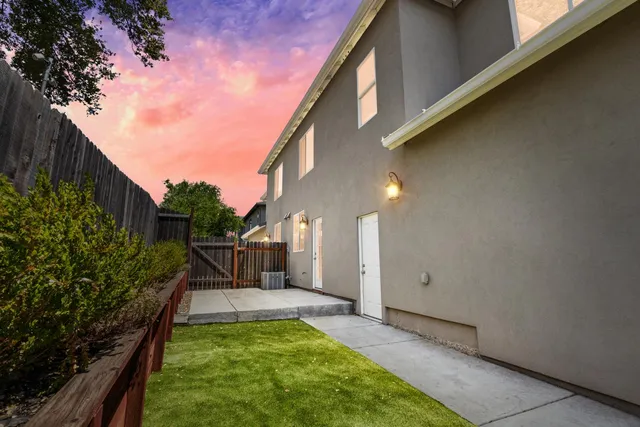 a view of a house with backyard and sitting area