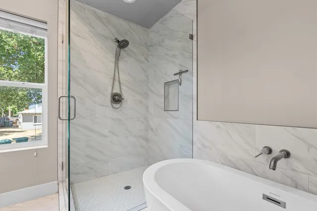 a bathroom with a tub and shower