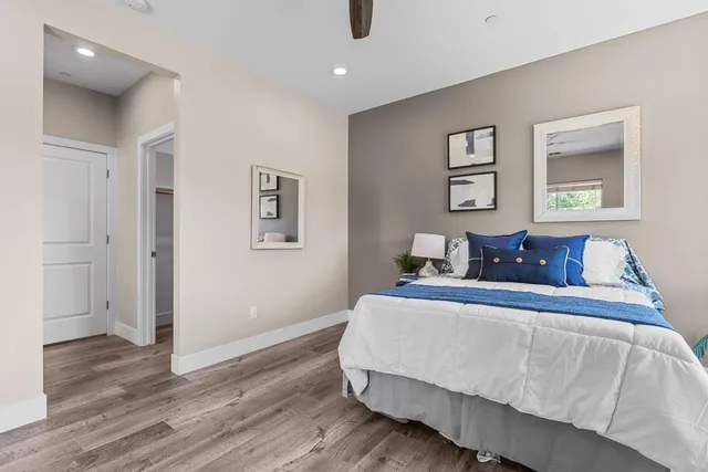 a bedroom with bed and night stand