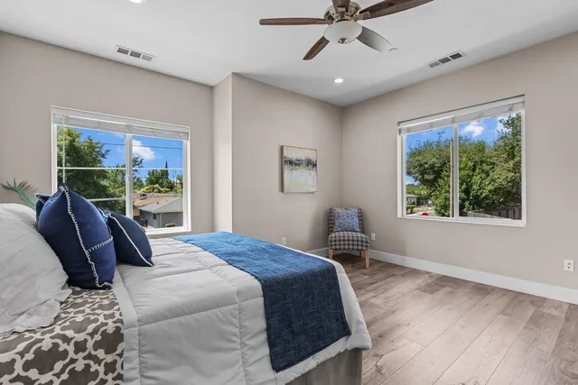 a bedroom with a large bed and a window