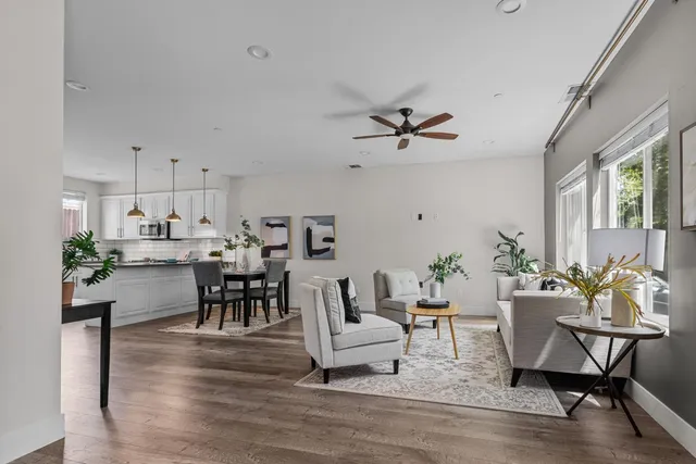 a living room with furniture kitchen view and a dining table