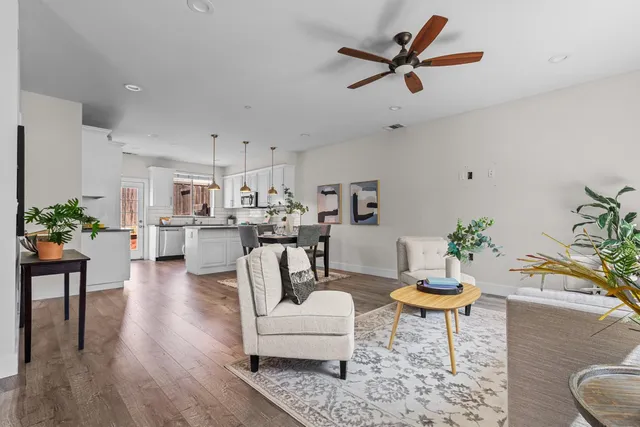 a living room with furniture and kitchen view