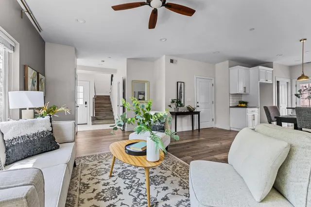 a living room with furniture a rug and a chandelier