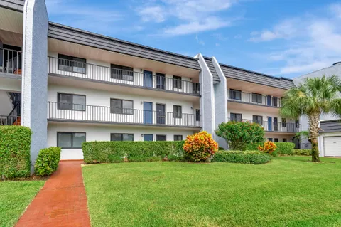 a front view of building with garden