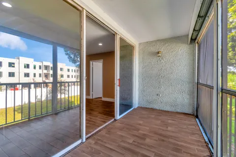 a view of hallway with wooden floor