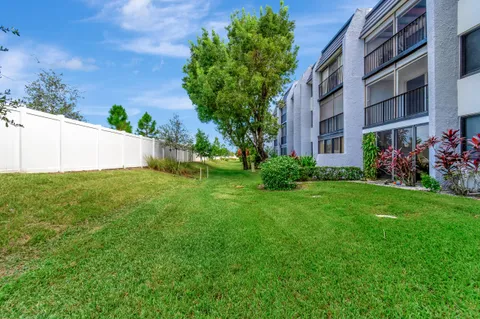 a view of a house with a yard and a garden