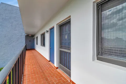 a view of balcony with floor to ceiling windows and walls