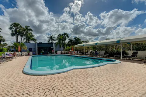 a view of a house with backyard and a garden