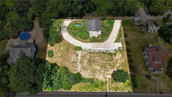 an aerial view of a house with a garden and swimming pool