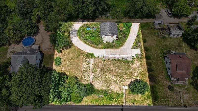 an aerial view of a house with a garden and swimming pool