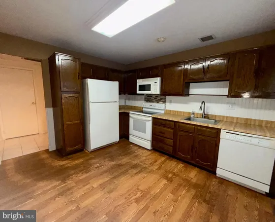 a kitchen with stainless steel appliances granite countertop a stove sink and refrigerator