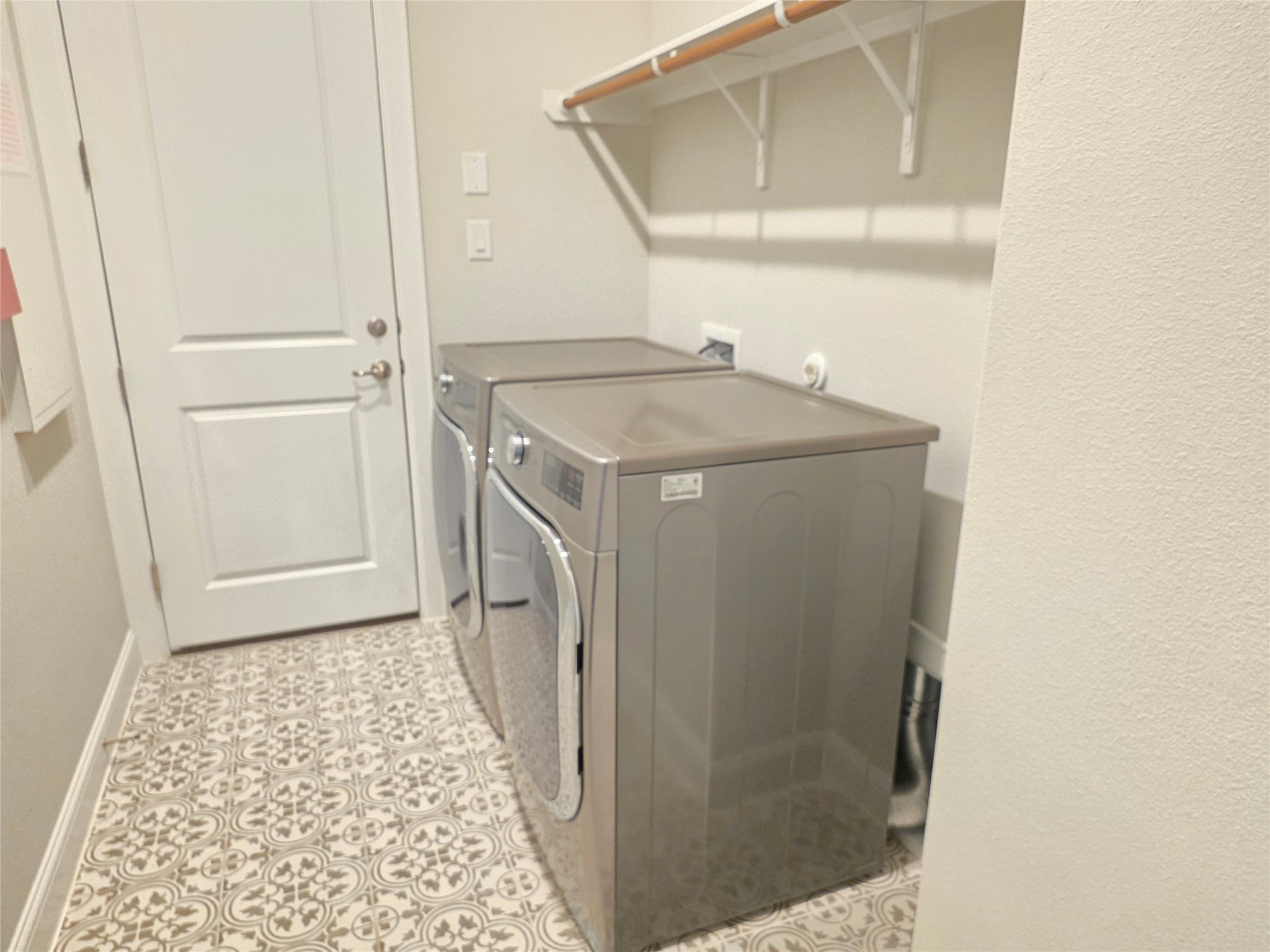 600 C-Bar Ranch Trail, Unit 121 Cedar Park, TX 78613 - Photo 14 of 32 A well-equipped laundry room offers convenience and patterned tile flooring.
