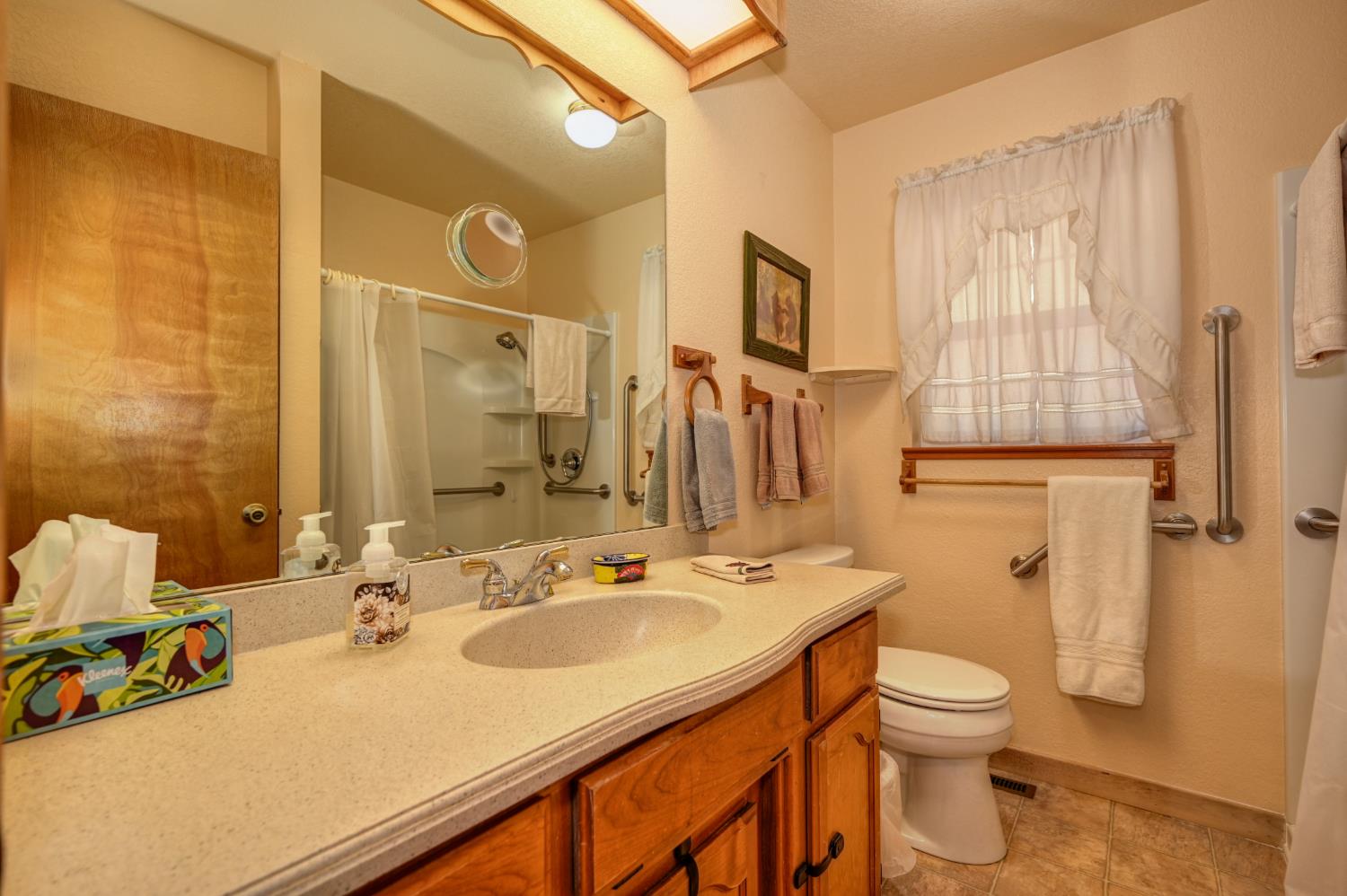 23998 Stable Road Sonora, CA 95370 - Photo 22 of 41 a bathroom with a sink toilet and shower