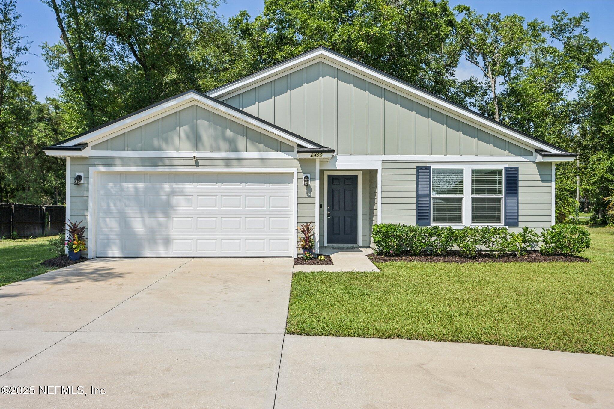 2400 Lundy Road Palatka, FL 32177 - Photo 1 of 34 a front view of a house with a yard and garage