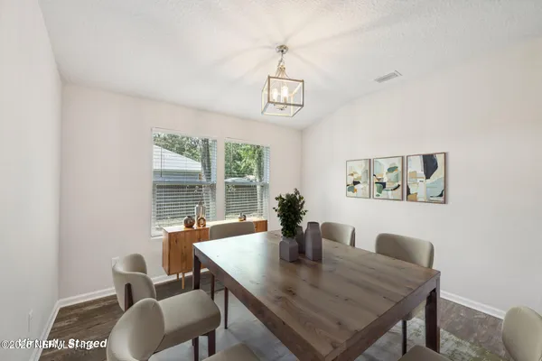 a view of a dining room with furniture and window
