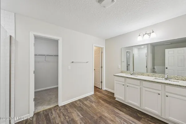 a bathroom with a double vanity sink and mirror