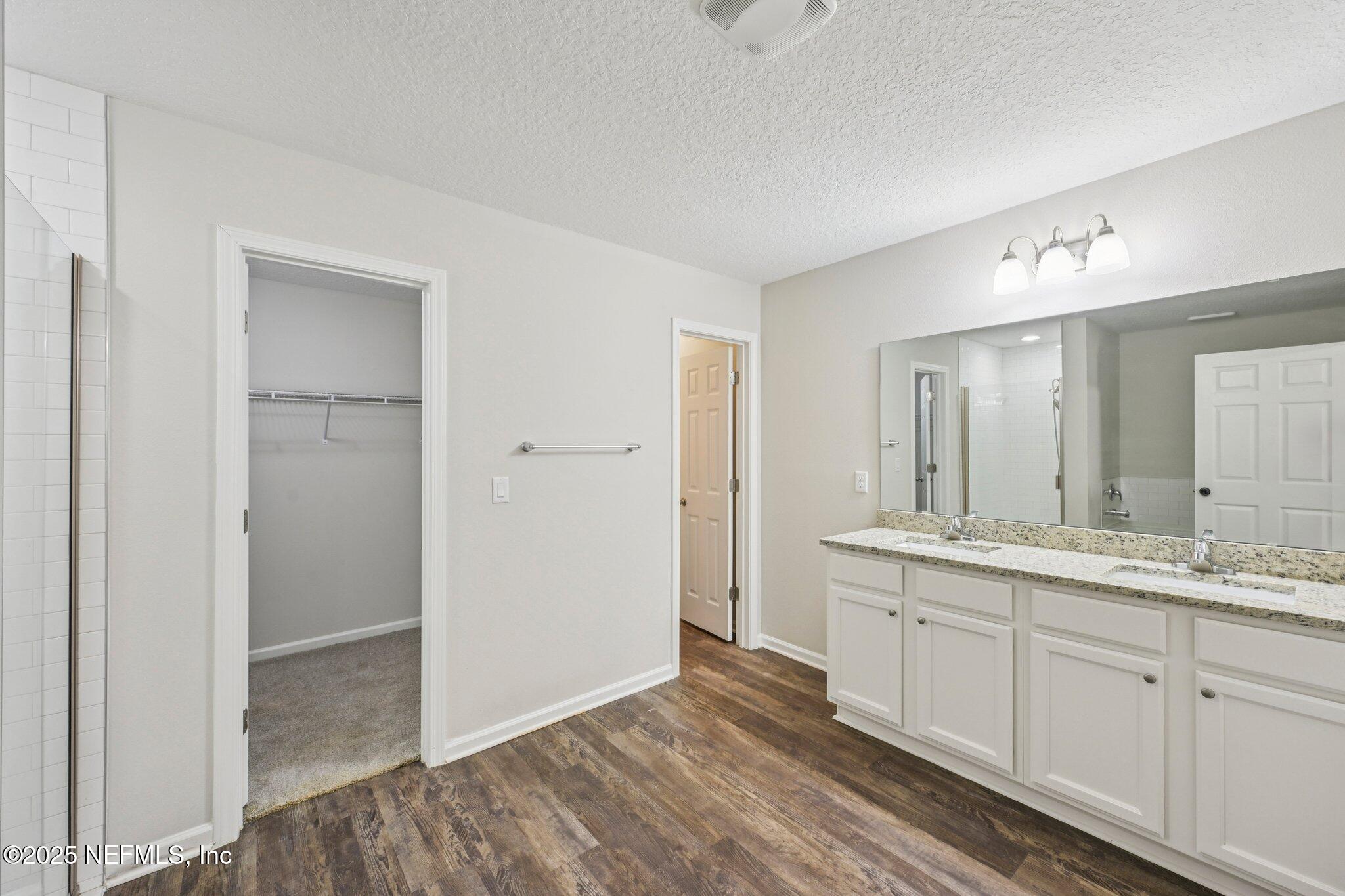 2400 Lundy Road Palatka, FL 32177 - Photo 16 of 34 a bathroom with a double vanity sink and mirror