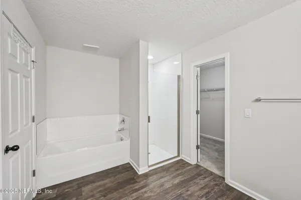 a bathroom with a bathtub and a shower