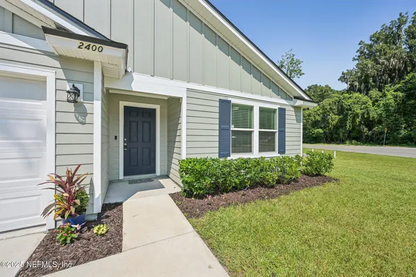 a front view of a house with garden