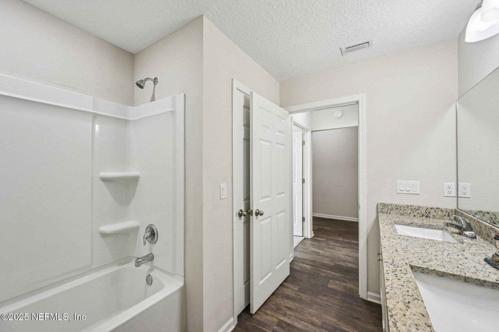 2400 Lundy Road Palatka, FL 32177 - Photo 22 of 34 a bathroom with a granite countertop sink a mirror bathtub and shower