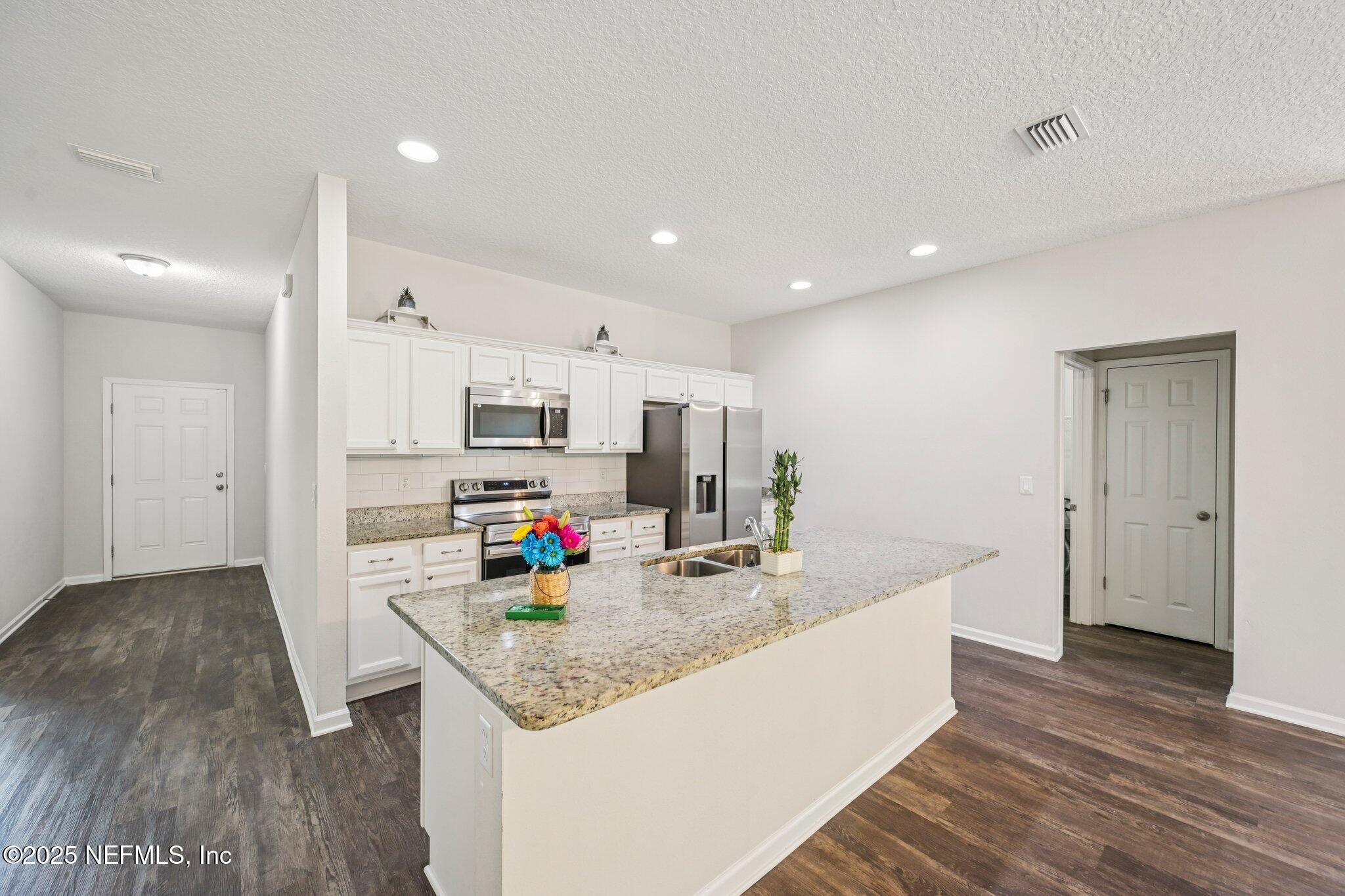 2400 Lundy Road Palatka, FL 32177 - Photo 3 of 34 a kitchen with stainless steel appliances a sink stove and refrigerator